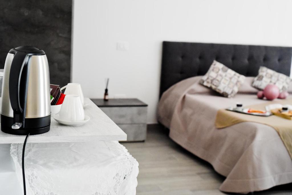 a bedroom with a bed and a coffee maker on a table at Profumo di Vigna - Roero in Occhetti