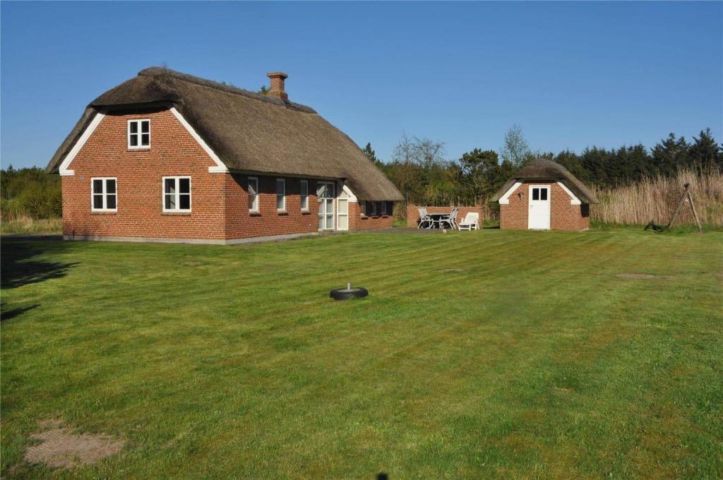 a large house with a grassy yard in front of it at 10850-Ulfborg-Vester-Mosevej-82 in Øby
