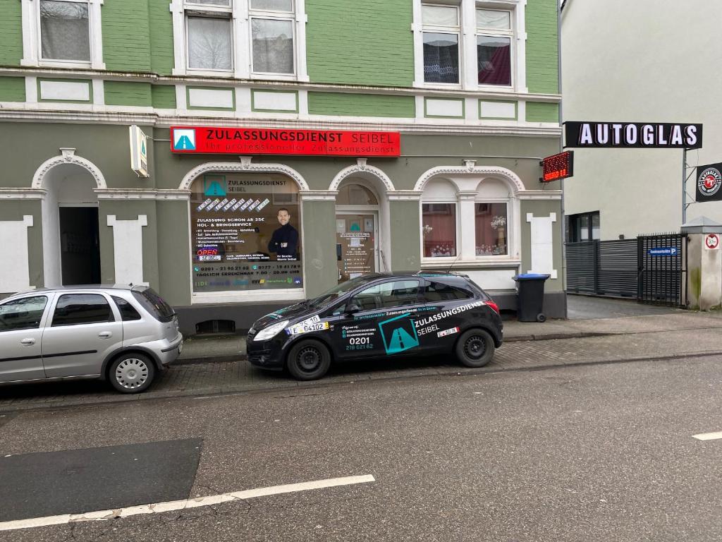 two cars parked on the side of a street at Seibel's SUITES - Big in Essen - Family & Group in Essen