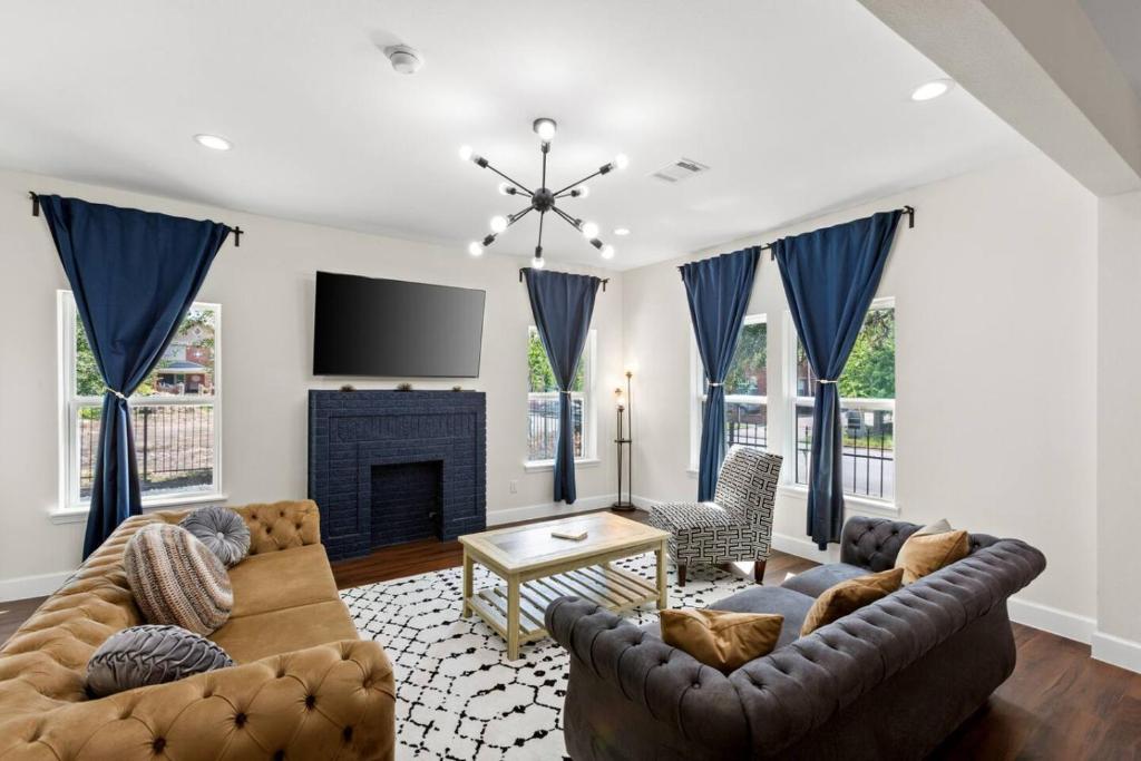 a living room with two couches and a fireplace at Gated 3BR Sleeps 7 Med Center NRG Downtown in Houston