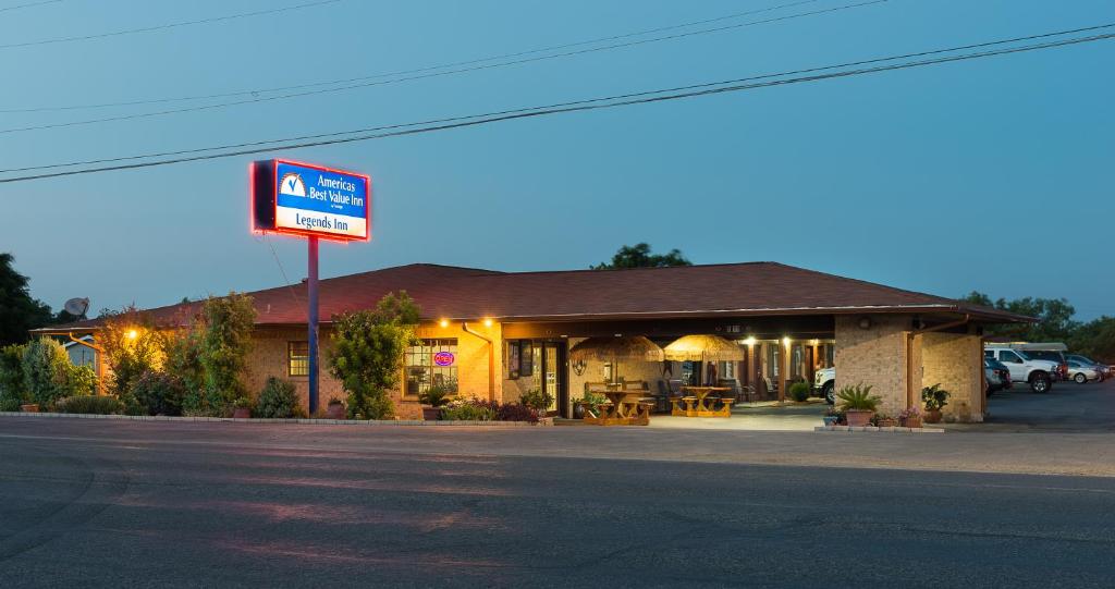 a gas station with a sign in front of it at Americas Best Value Inn - Legend's Inn in Junction