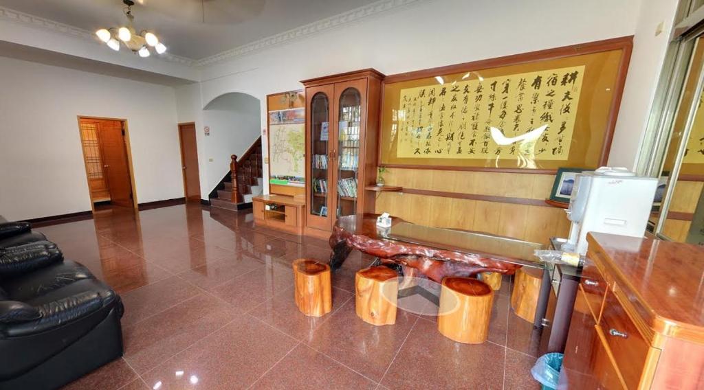 a living room with a bench and a wall at Alishan Fenqihu Green Land Homestay in Guanghua