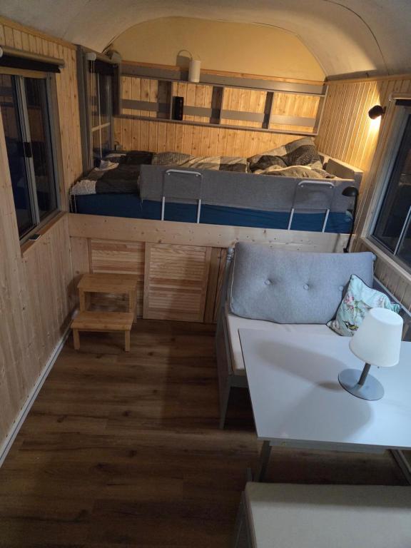 a small room with two beds and a couch at Tinyhaus, Bauwagen, Noltenius in Bülstedt