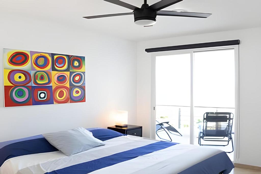 a bedroom with a bed and a painting on the wall at Vista Colorada in El Bedito