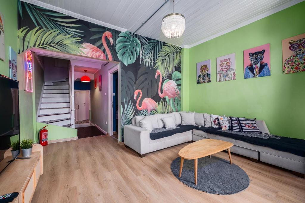 a living room with a couch and pink flamingos on the wall at Cozy Private House in Kadikoy in Istanbul