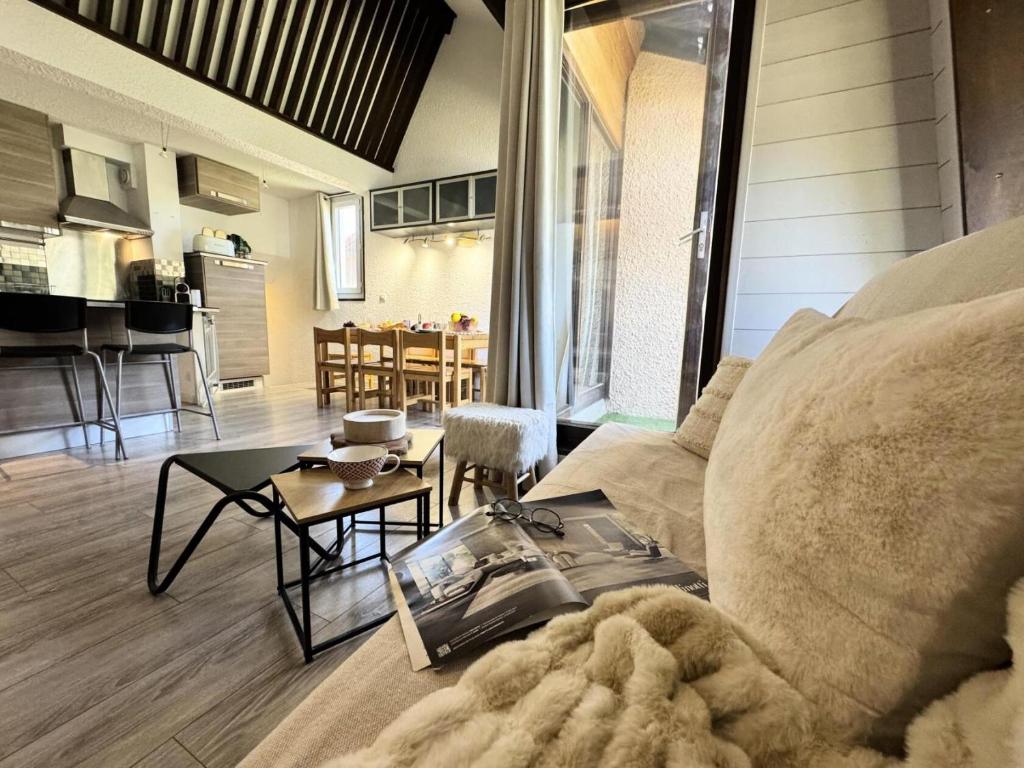 a living room with a couch and a table at Résidence Le Hameau - LE HAMEAU MAE-0103 in Vars