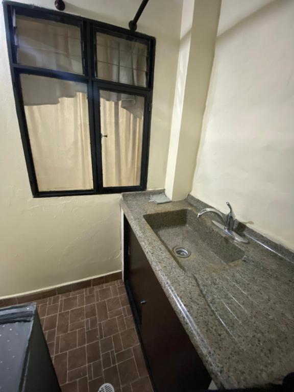 a bathroom with a sink and a window at Apartamento Central Envigado in Envigado