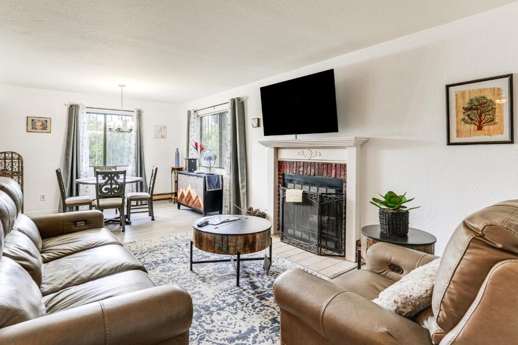 a living room with two couches and a fireplace at 1 Mi to Whiskey Row and Town Sq Remote Work Hub! in Prescott
