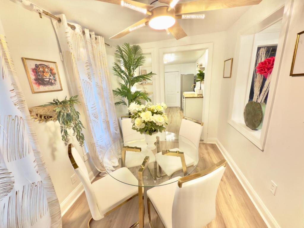 a dining room with a glass table and white chairs at Home away from home in Dover