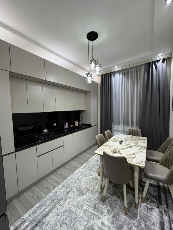 a kitchen and dining room with a table and chairs at Anisa guest house in Samarkand