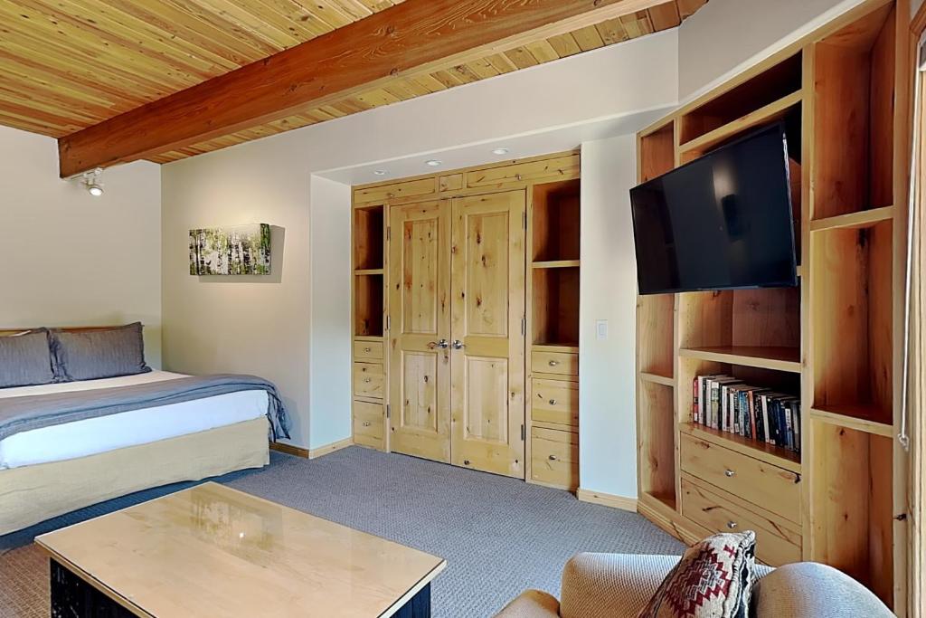 a bedroom with a bed and a flat screen tv at Timberline Condominiums Studio Deluxe Unit 217 in Snowmass Village
