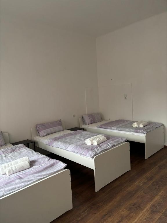 a group of three beds in a room at Apartment in Niederdorla