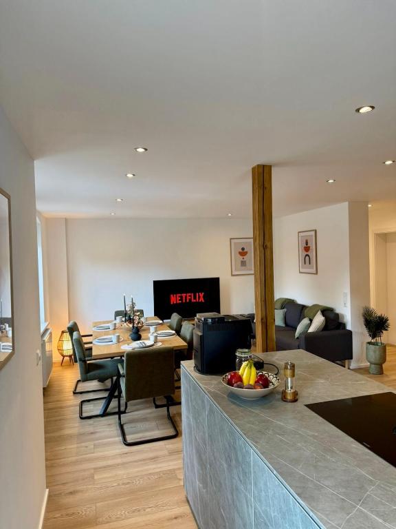 a living room with a table and a couch at Lupi Grey - stylish und luxury Apartment in Buchen