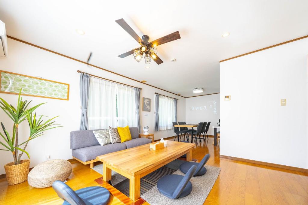 a living room with a couch and a table at Soyo in Tsumagoi