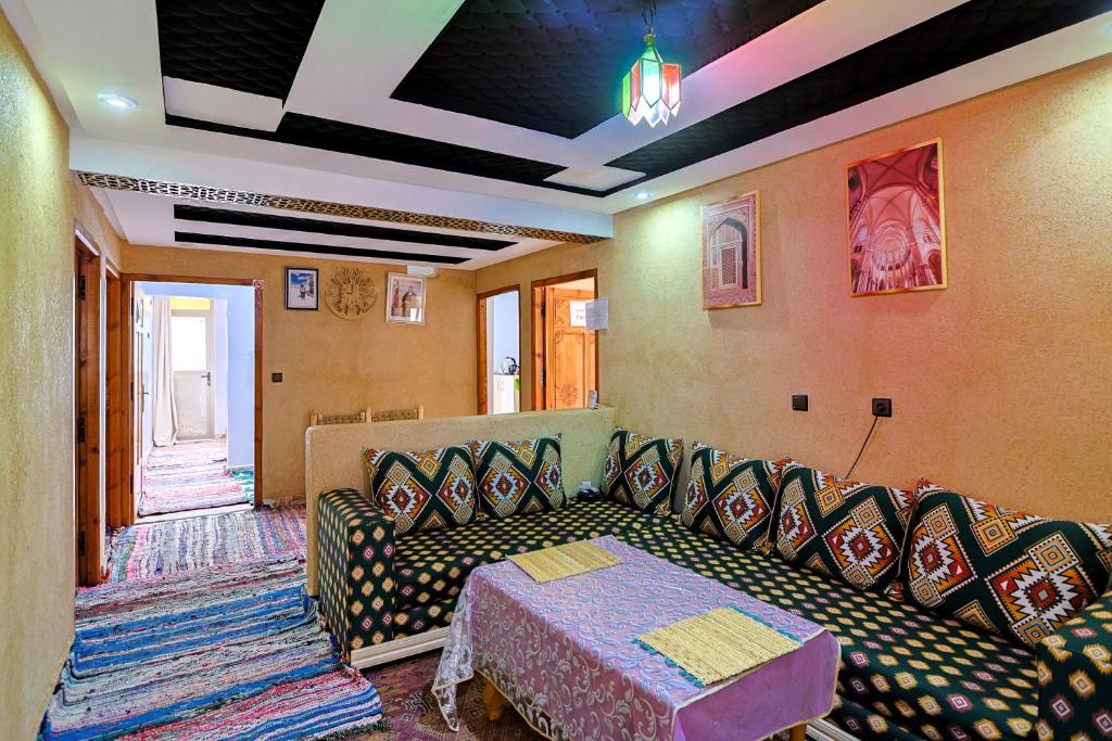 a living room with a couch and a table at Dar Tamatert in Tamatert