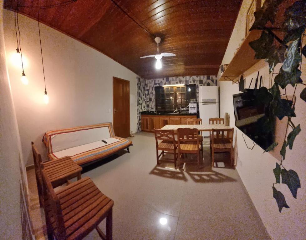 a room with a bed and a table and chairs at 03 Apartamento de praia com ótima localização e piscina in São Sebastião