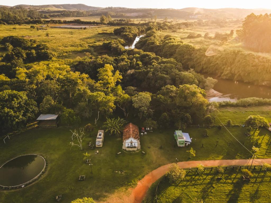 an aerial view of a farm with trees and a river at Camping Tiradentes in Tiradentes