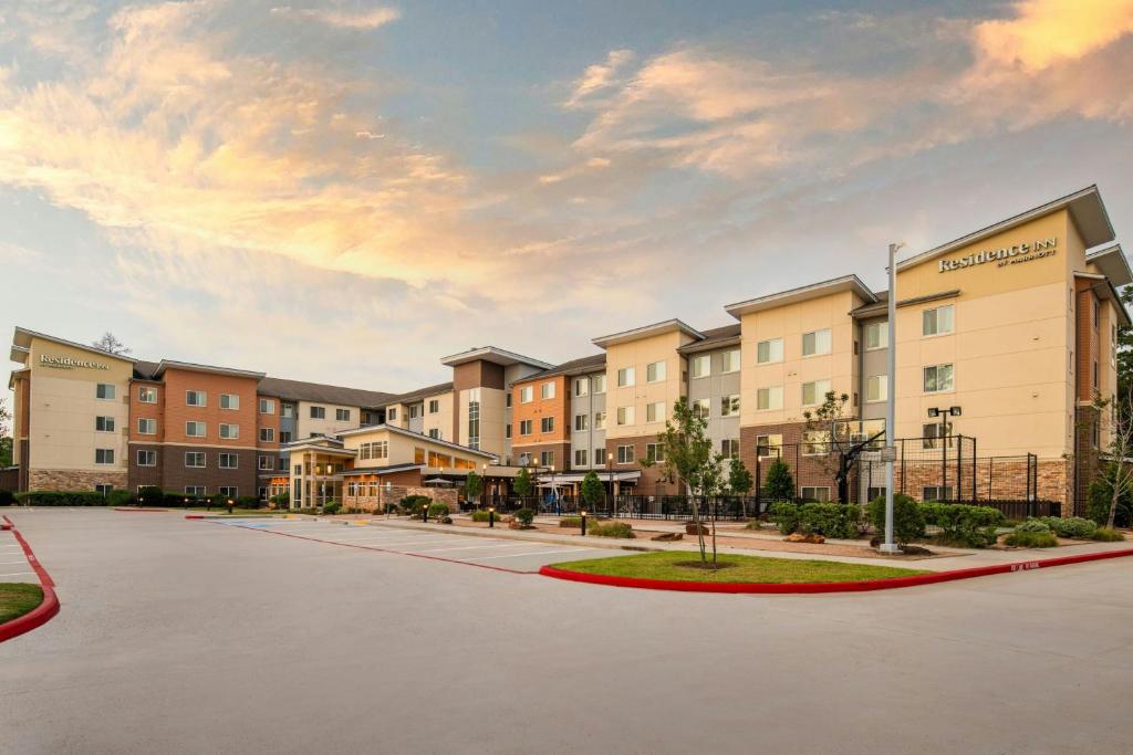 a rendering of an apartment complex with a parking lot at Residence Inn by Marriott Houston City Place in Spring