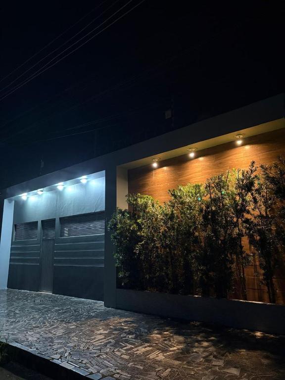 a building with a bush on the side of it at Aconchego de luxo para COP 30 in Castanhal