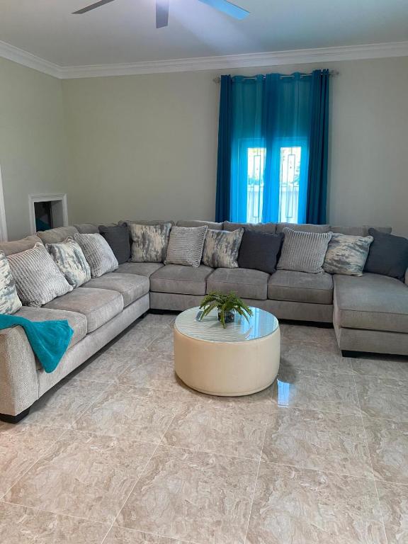 a living room with a couch and a coffee table at Tropical Palm Townhouse in Nassau