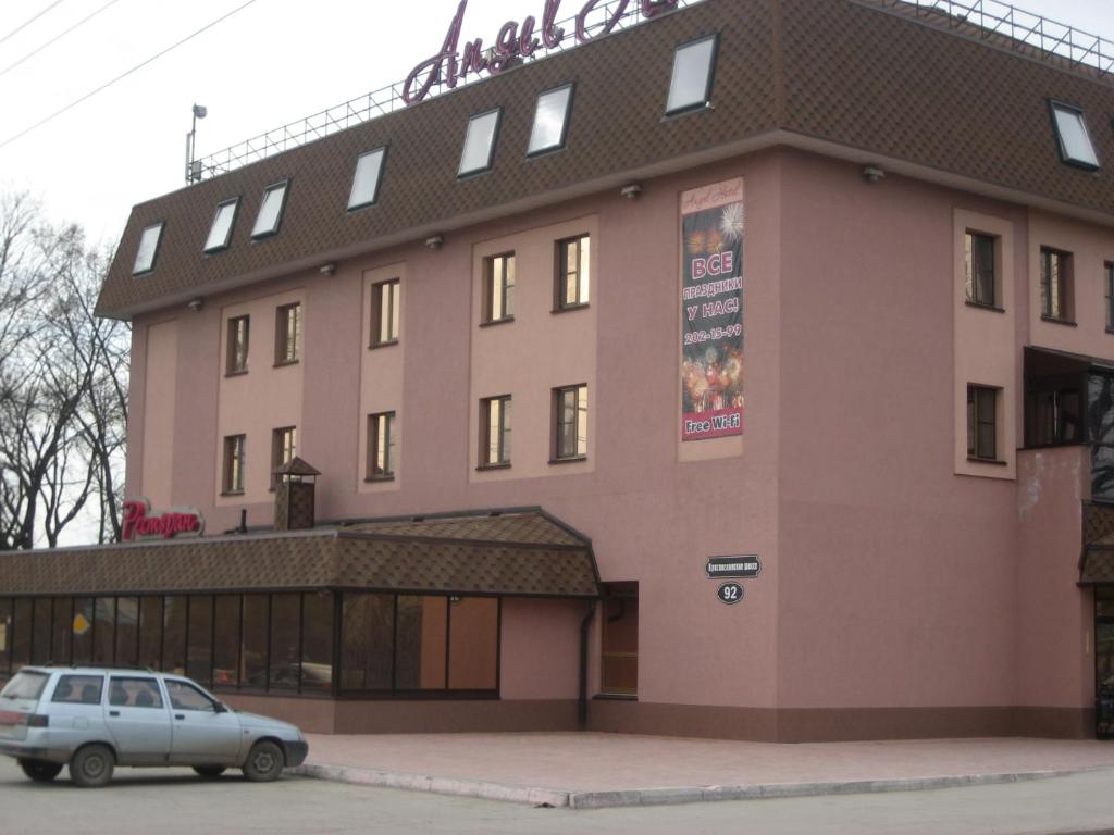 a building with a car parked in front of it at Angel Hotel in Samara