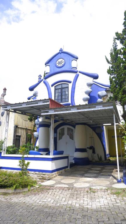a blue and white house with a window at Villa Dalia Puncak NA4-11 in Cianjur