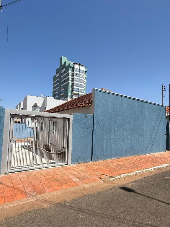 a building with a gate on the side of a street at Brisa Suítes in Rio Verde