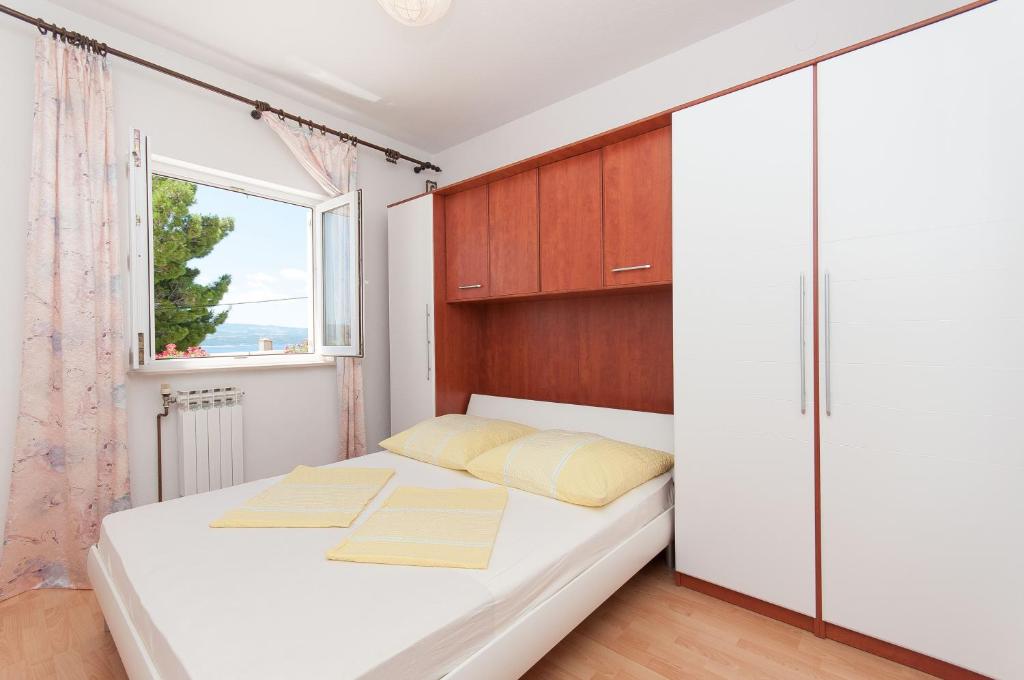 Postel nebo postele na pokoji v ubytování Apartmani Vesna