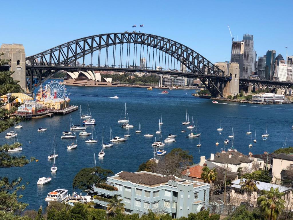 a view of a harbor with boats in the water with a bridge at Breathtaking Sydney Harbour Views from Stylish Harbourside Studio in Sydney