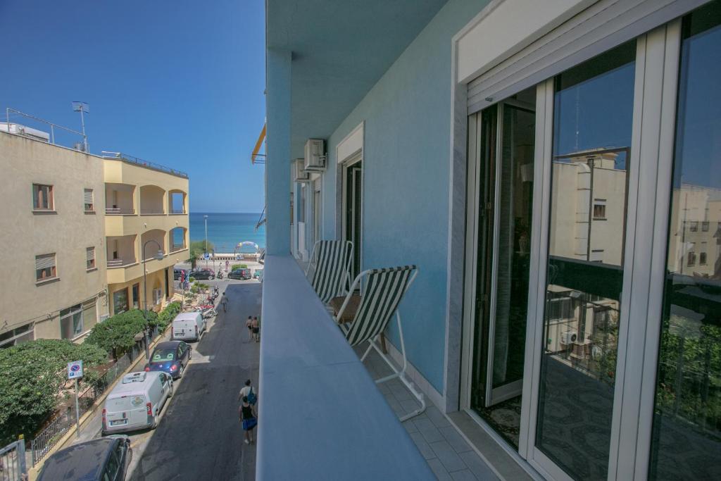 a balcony of a building with a view of a street at Archimede Lounge in Cefalù