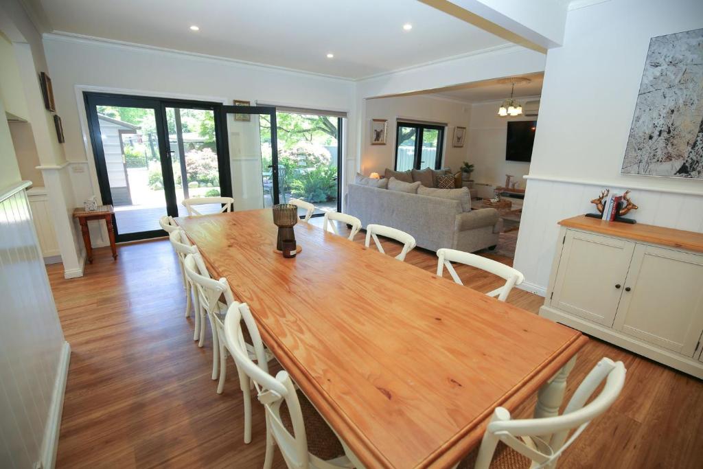 a large wooden table and chairs in a living room at Battenberg At Bright in Bright
