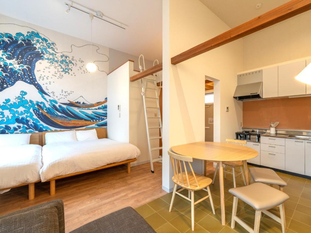 a small apartment with a kitchen and a dining room at Oneness Apartment Akasaka 赤坂 in Fukuoka