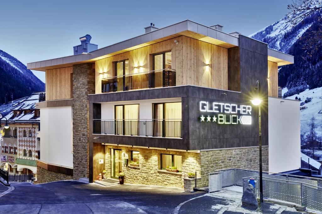 a building in the mountains with a sign on it at Gletscherblick B&B in Ischgl