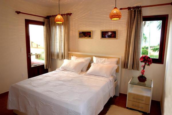 Кровать или кровати в номере Pousada Corais do Sul