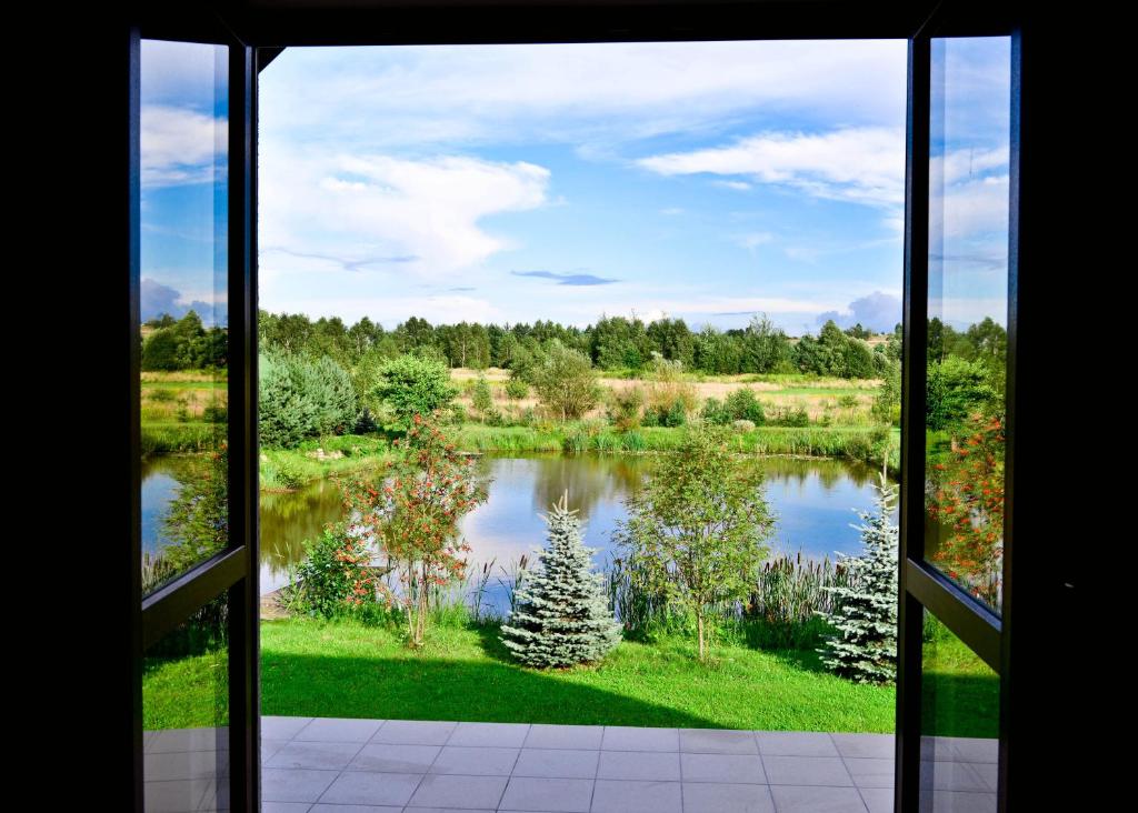 a view of a lake from a window at Agroturystyka Nad Stawem in Górno