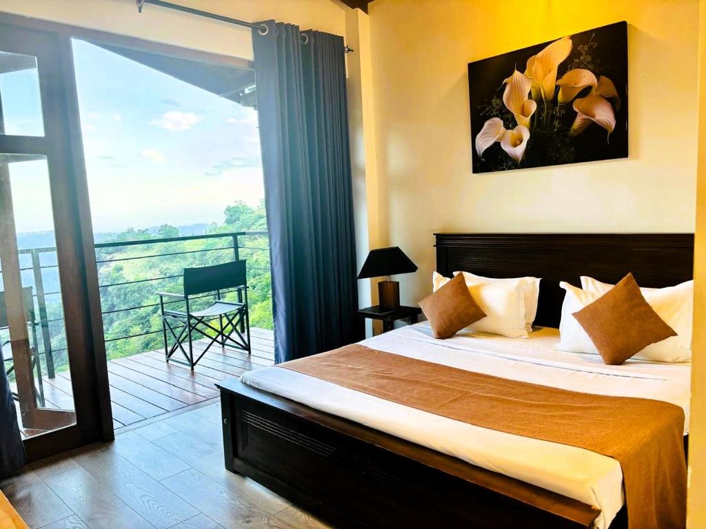 a bedroom with a large bed and a balcony at Benjamin Cottage Haputale in Haputale