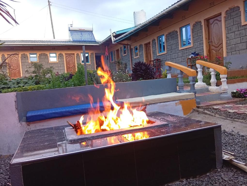 a fire pit in a yard in front of a house at JC ITEN Guest House in Iten
