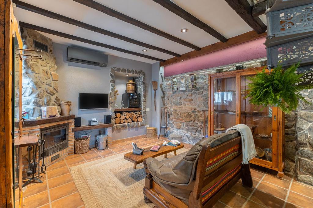 a large living room with a stone wall at El Rincon De San Jose in Marjaliza