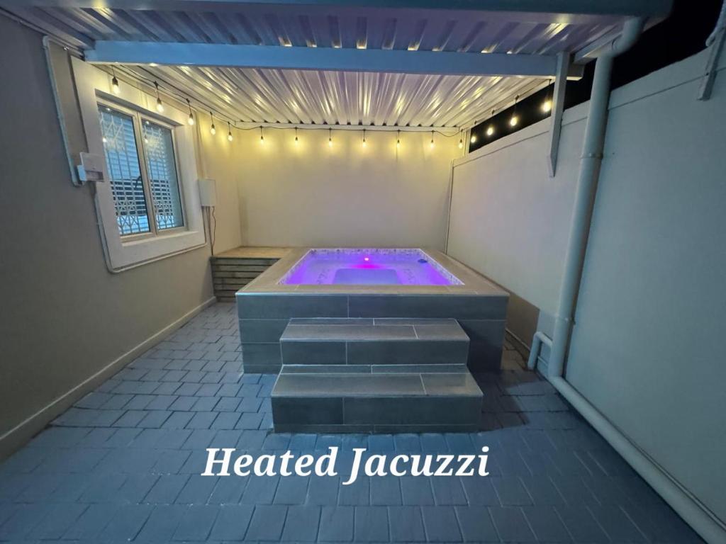 a heated jacuzzi tub in a room with a window at Durban Holiday Apartments by Mieli Estates , Unit 6 in Durban