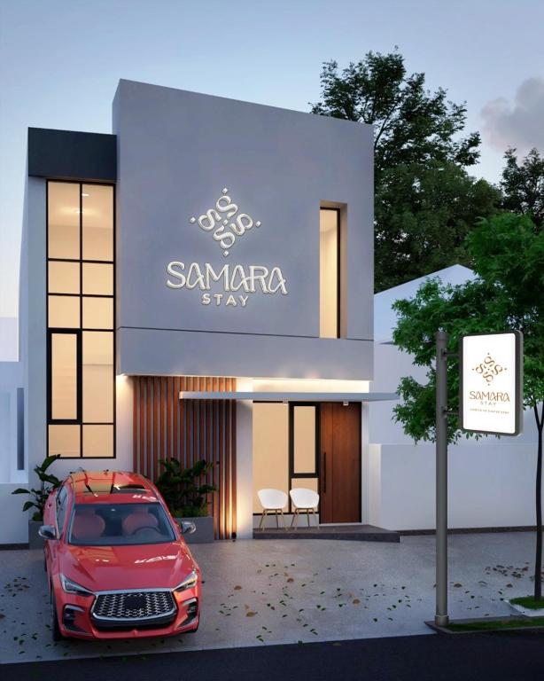 a red car parked in front of a building at Samara Stay by Sinergi in Kalibanteng-kidul