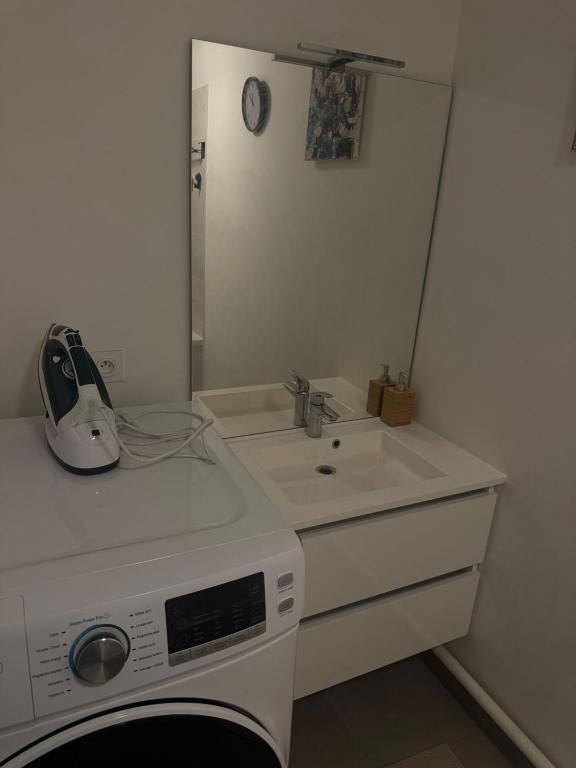a kitchen with a sink and a washing machine at Building carré d eden in Clamart