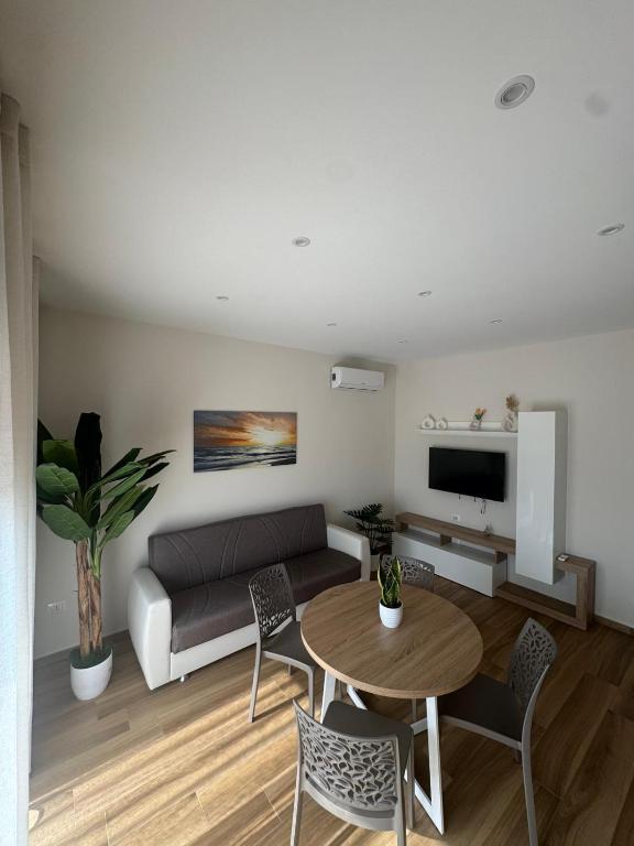 a living room with a couch and a table at SICILIA FIERA Apartment in Misterbianco