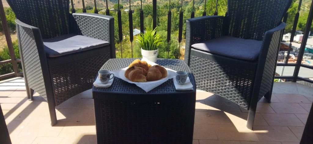a plate of pastries on a table on a patio at House Calamigna in Ventimiglia di Sicilia