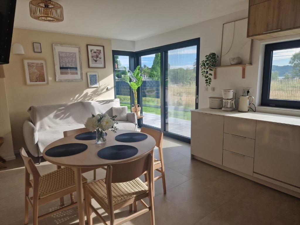 a kitchen and living room with a table and chairs at Villa Seaview in Nadole