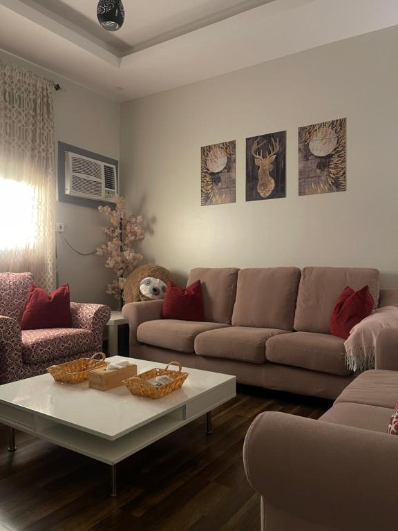 a living room with a couch and a coffee table at شقق فندقية هادئة بحي السلامة in Jeddah