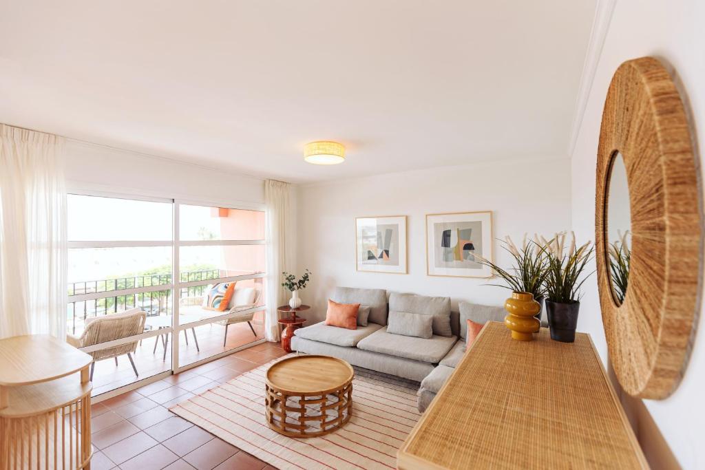 a living room with a couch and a table at Apartamento en Pasito Blanco PTOM11 in Pasito Blanco