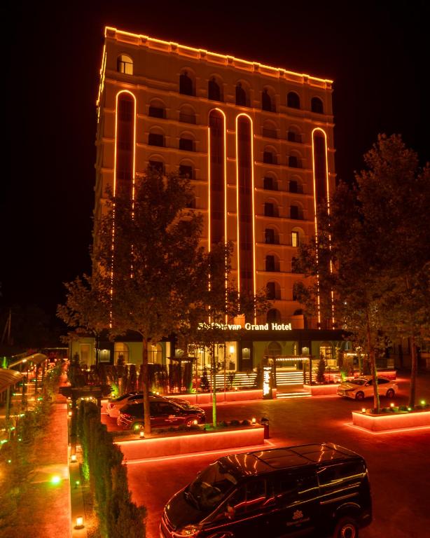 a car parked in front of a building at night at Shirvan Grand Hotel Shamakhi in Shamakhi