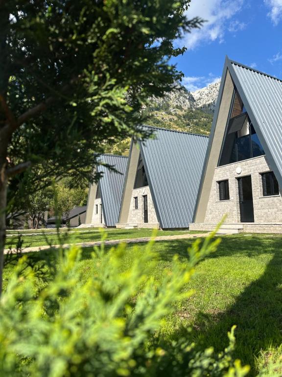 a house with a metal roof on top of a field at The Overlook in Bogë