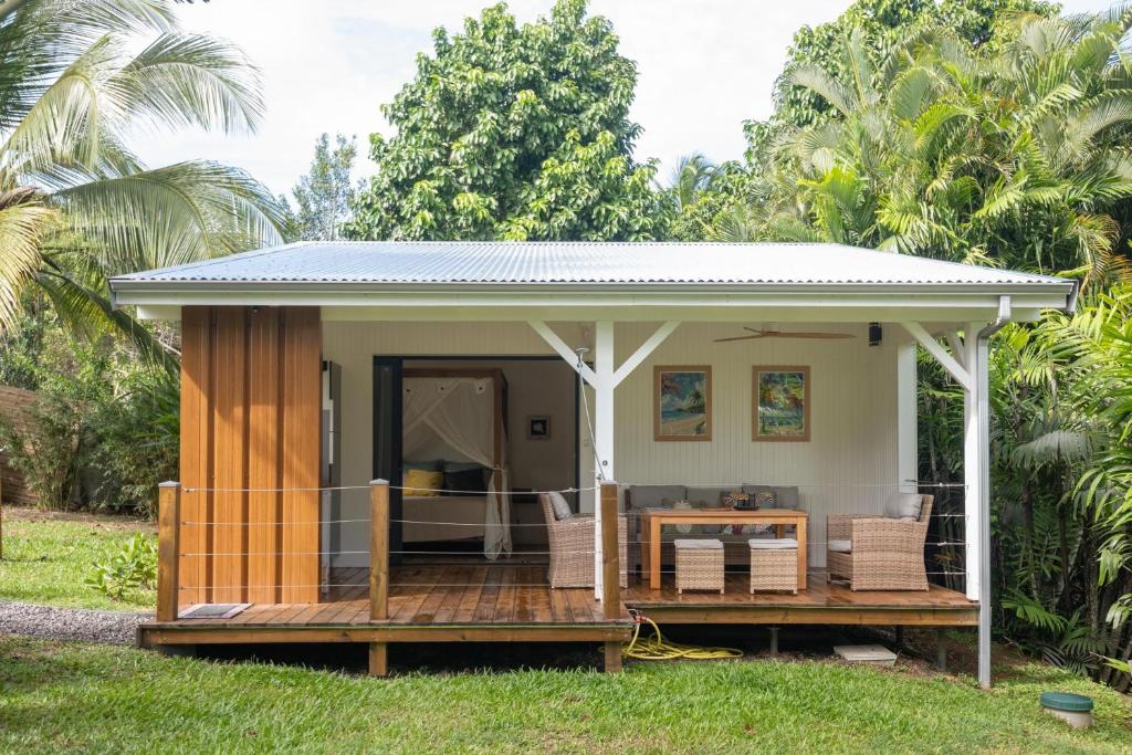 a tiny house on a deck with a gazebo at Sanoa lodge - Bungalow Climatisé in Roussel