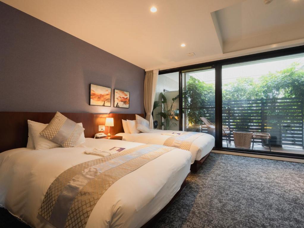 Giường trong phòng chung tại Hotel Tokyo Trip Ueno Nishi Nippori